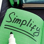 Image showing a note book and marker with the word 'Simplify' written in large print